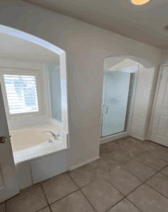 The remodeled bathroom features a refreshed and modern design, with upgraded fixtures, new tiles, improved lighting, and a clean, polished finish.