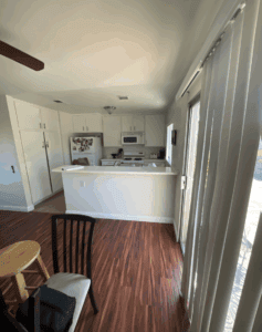 The kitchen has been fully restored, featuring repaired and refinished surfaces, updated fixtures, and a clean, polished look.