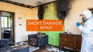 Smoke damage repair scene in a living room, featuring a worker in protective gear assessing charred walls and furniture, with a prominent "SMOKE DAMAGE REPAIR" text overlay.