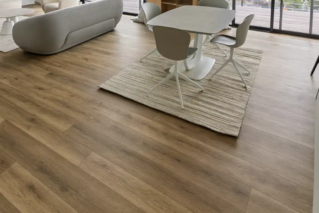 Modern interior with light wood flooring, dining table and chairs, showcasing Sparkle Restoration's flooring installation services.